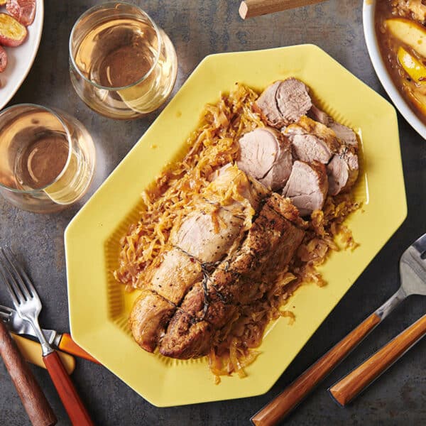 Braised Pork with Cabbage and Apples on a light yellow platter.
