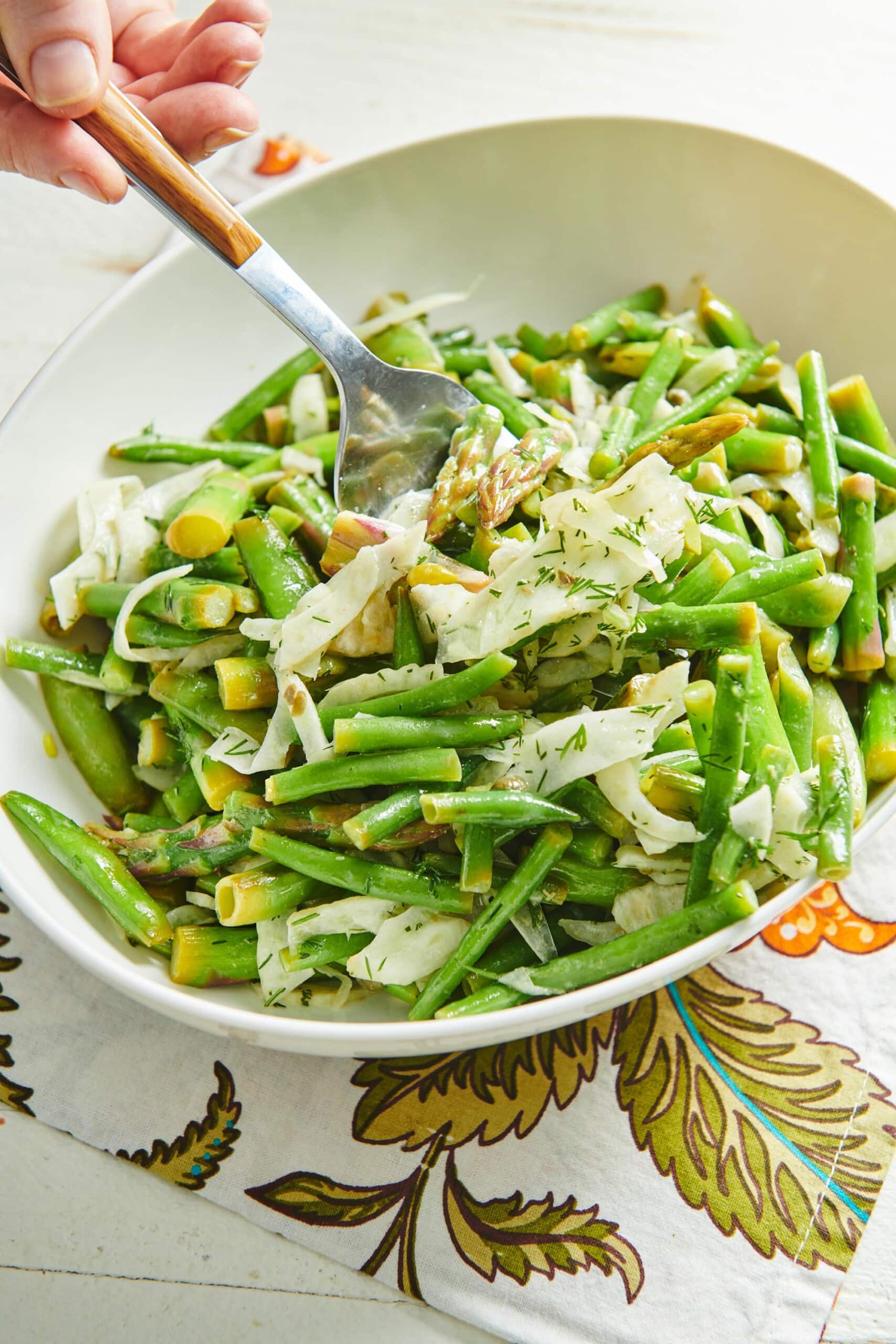 Spoon in a bowl of Spring Vegetable Salad.