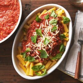 Turkey tomato sauce over pasta on plate.