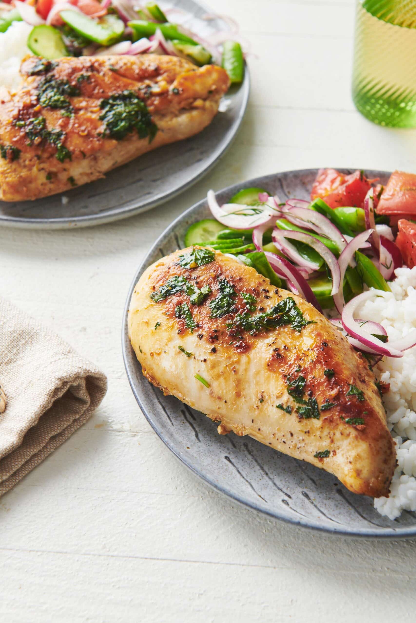 Plate with rice, salad, tomato, and Cilantro Lime Chicken.