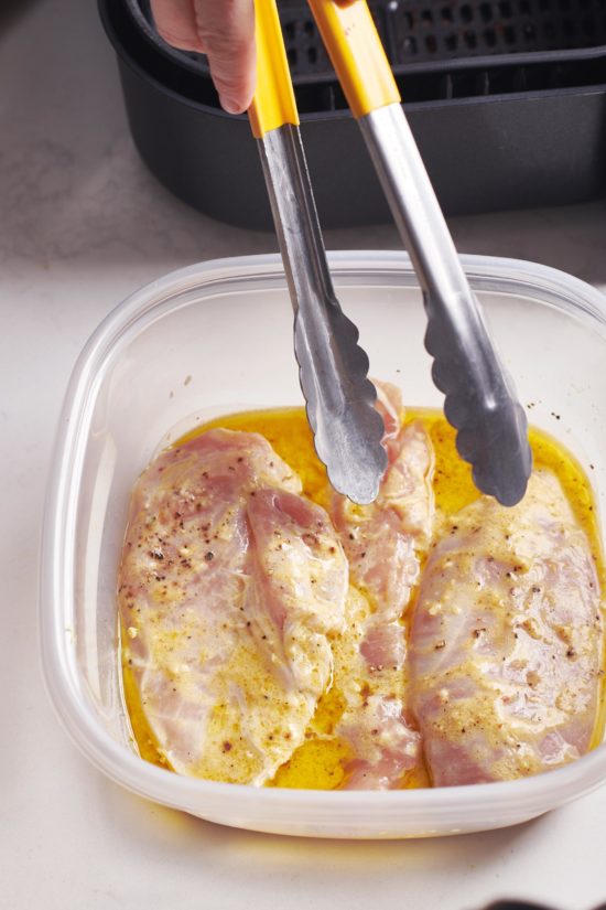 Chicken Breasts marinating in a lemon garlic mixture.