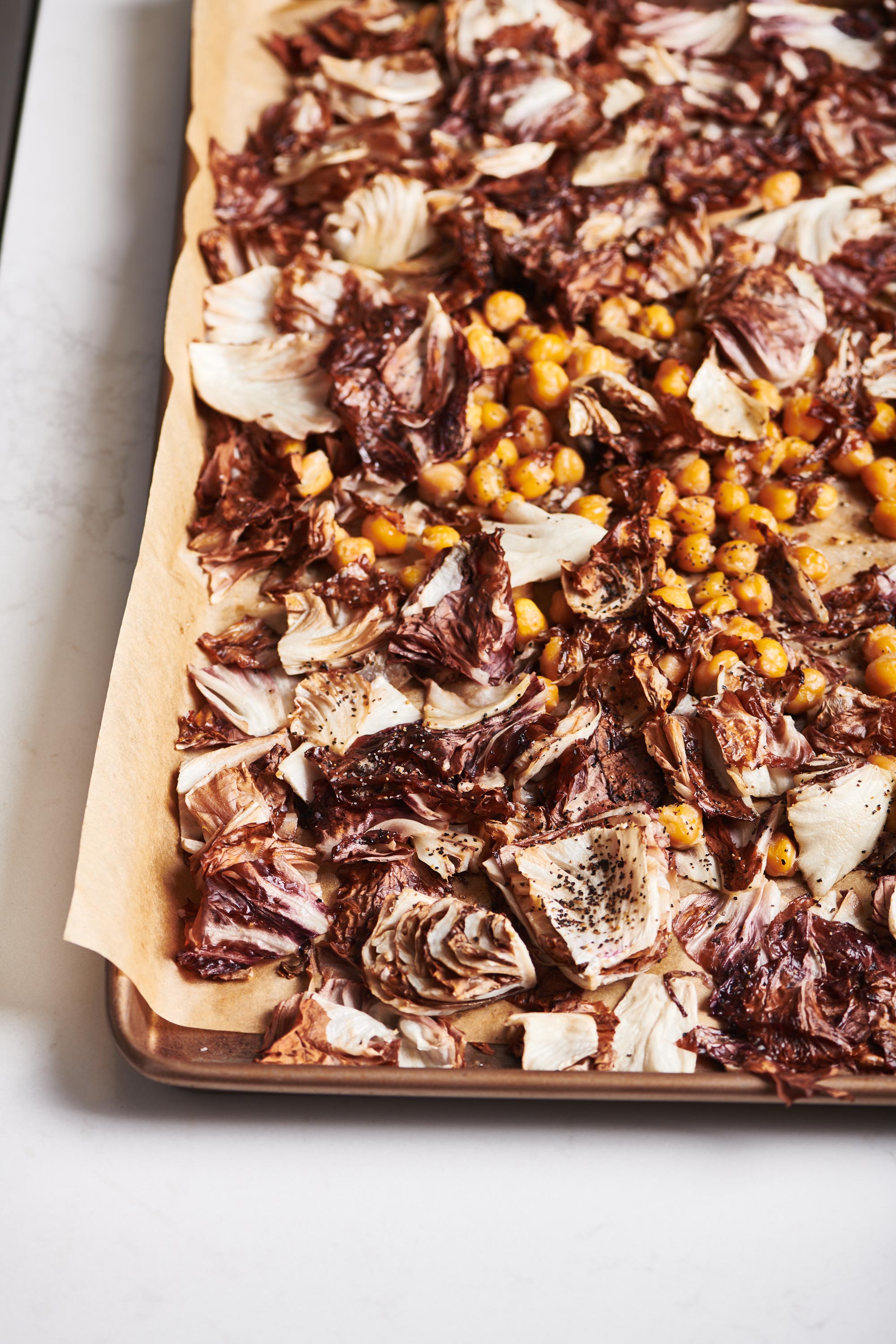 Roasted Chickpeas and radicchio on a lined baking sheet.