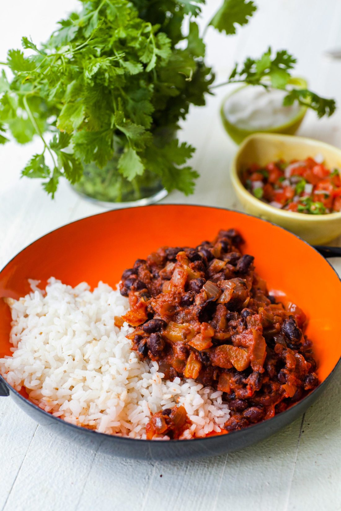 Black Beans and Rice in an orange and black bowl.