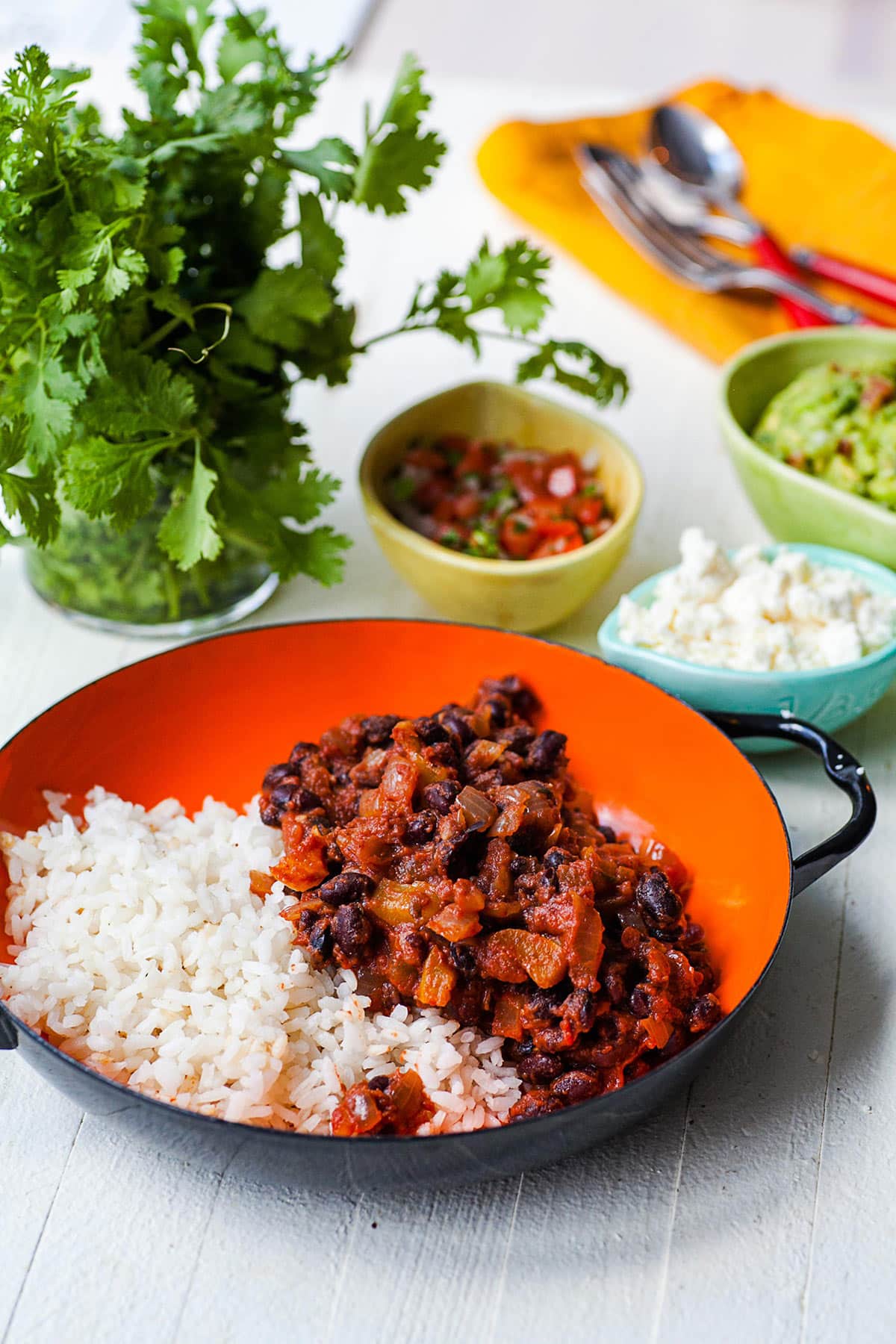Black Beans and Rice in an orange and black bowl.
