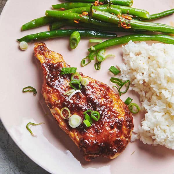Plate with honey garlic chicken, rice, and green beans.