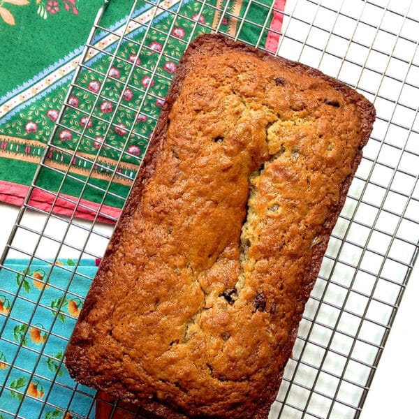 Banana bread loaf on wire baking rack.