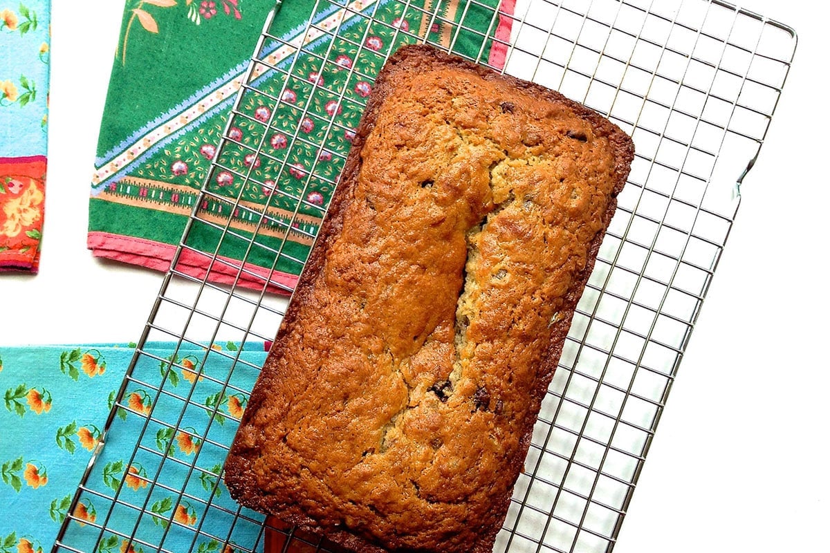 Banana bread loaf on wire baking rack.