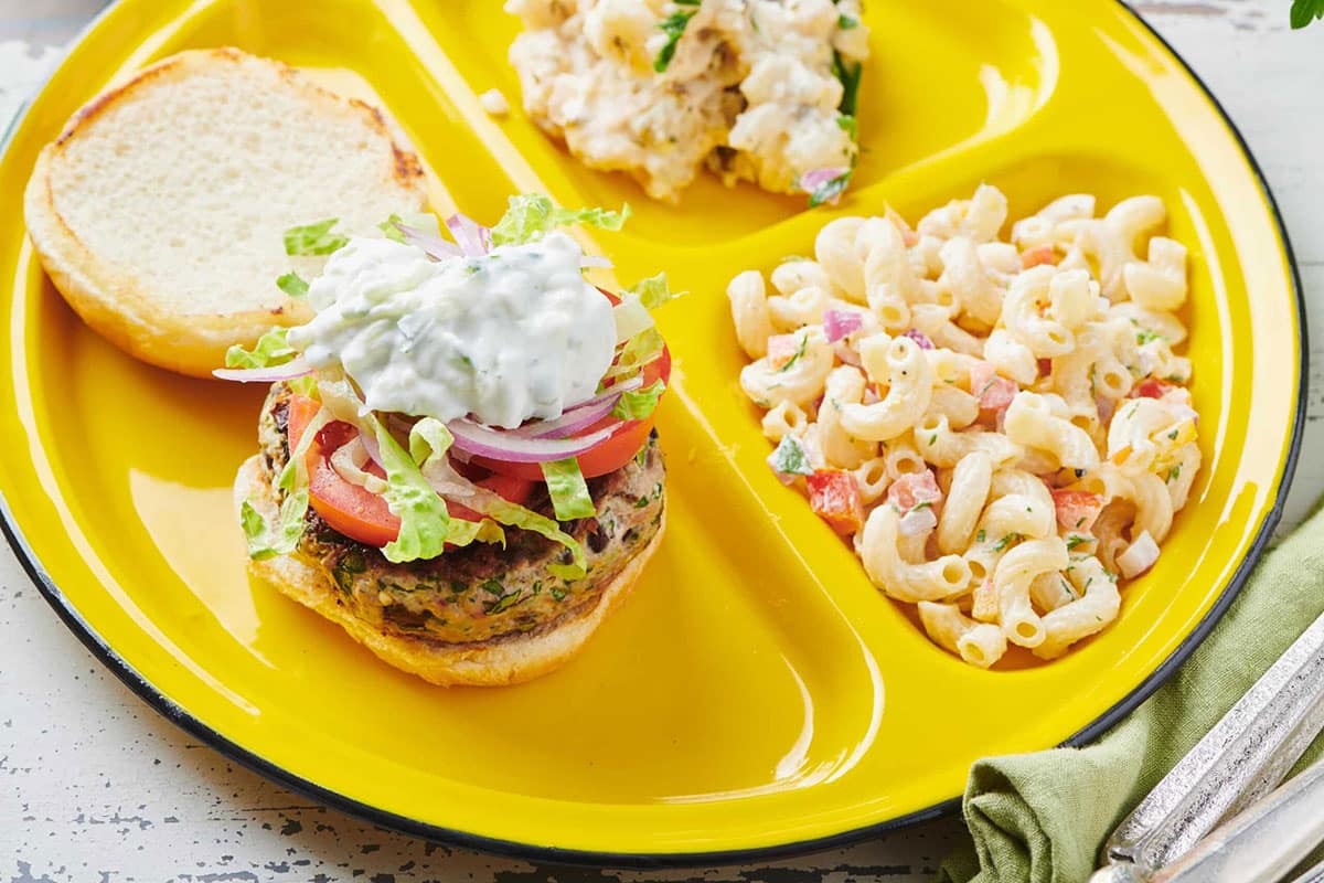 Macaroni Salad on a plate with a turkey burger.