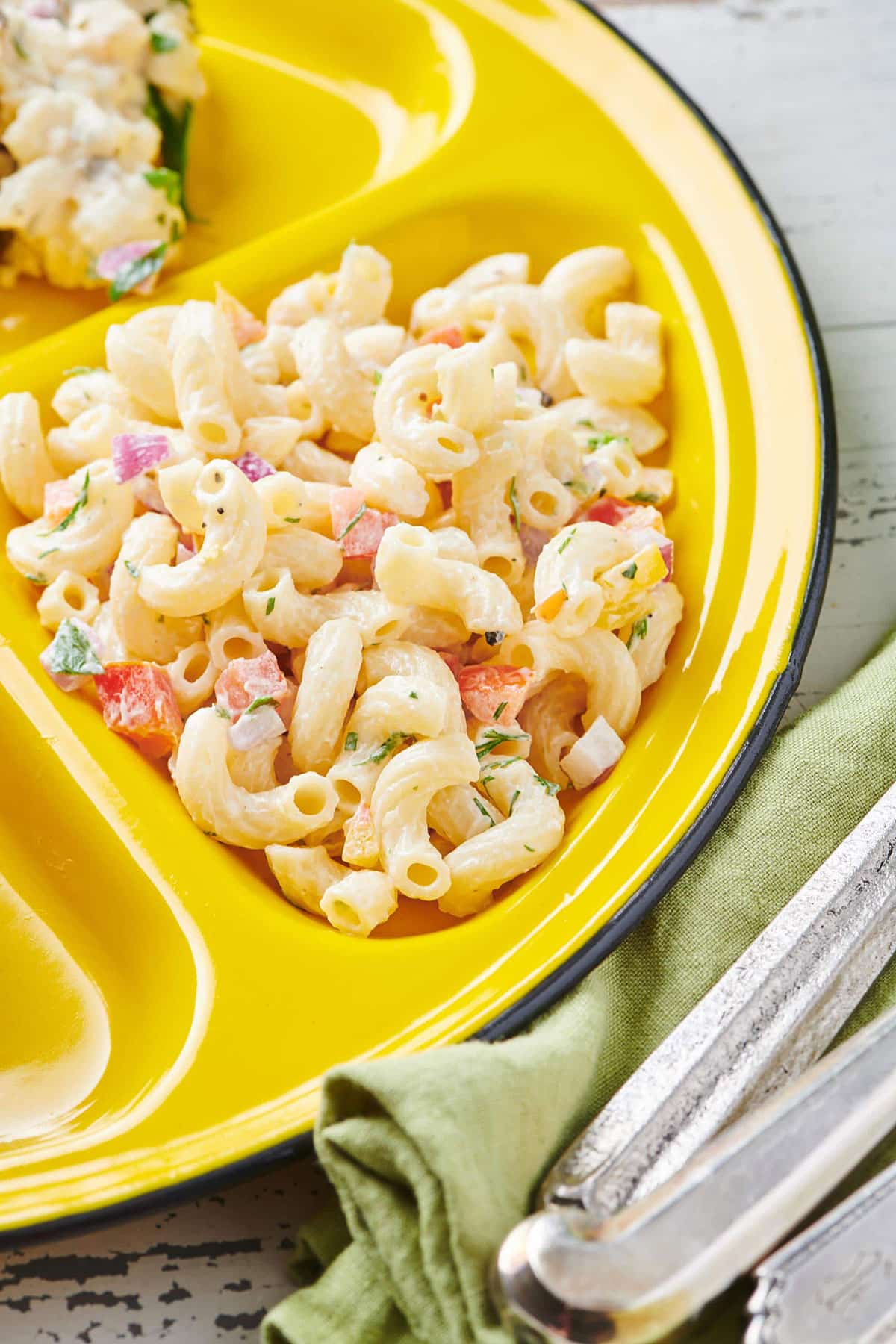 Macaroni salad on a yellow plate.