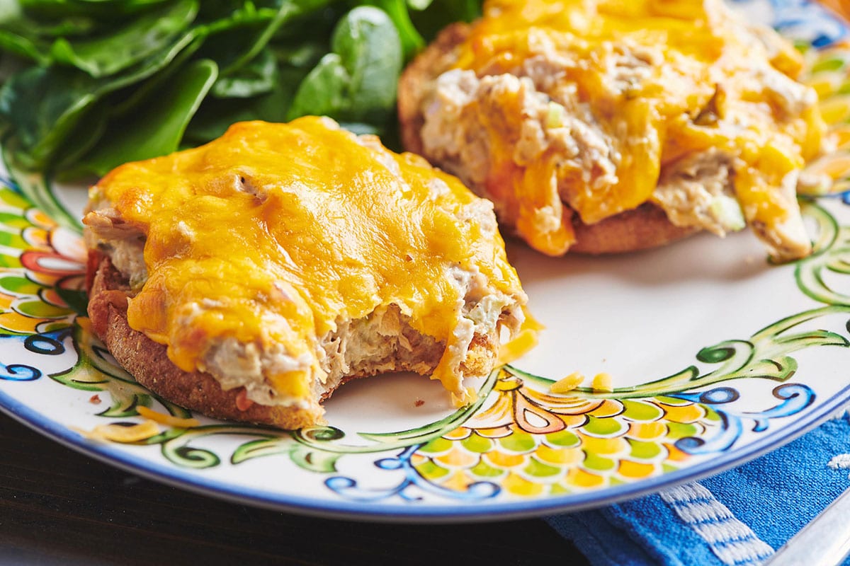 Plate with open-faced tuna melt sandwiches and lettuce.