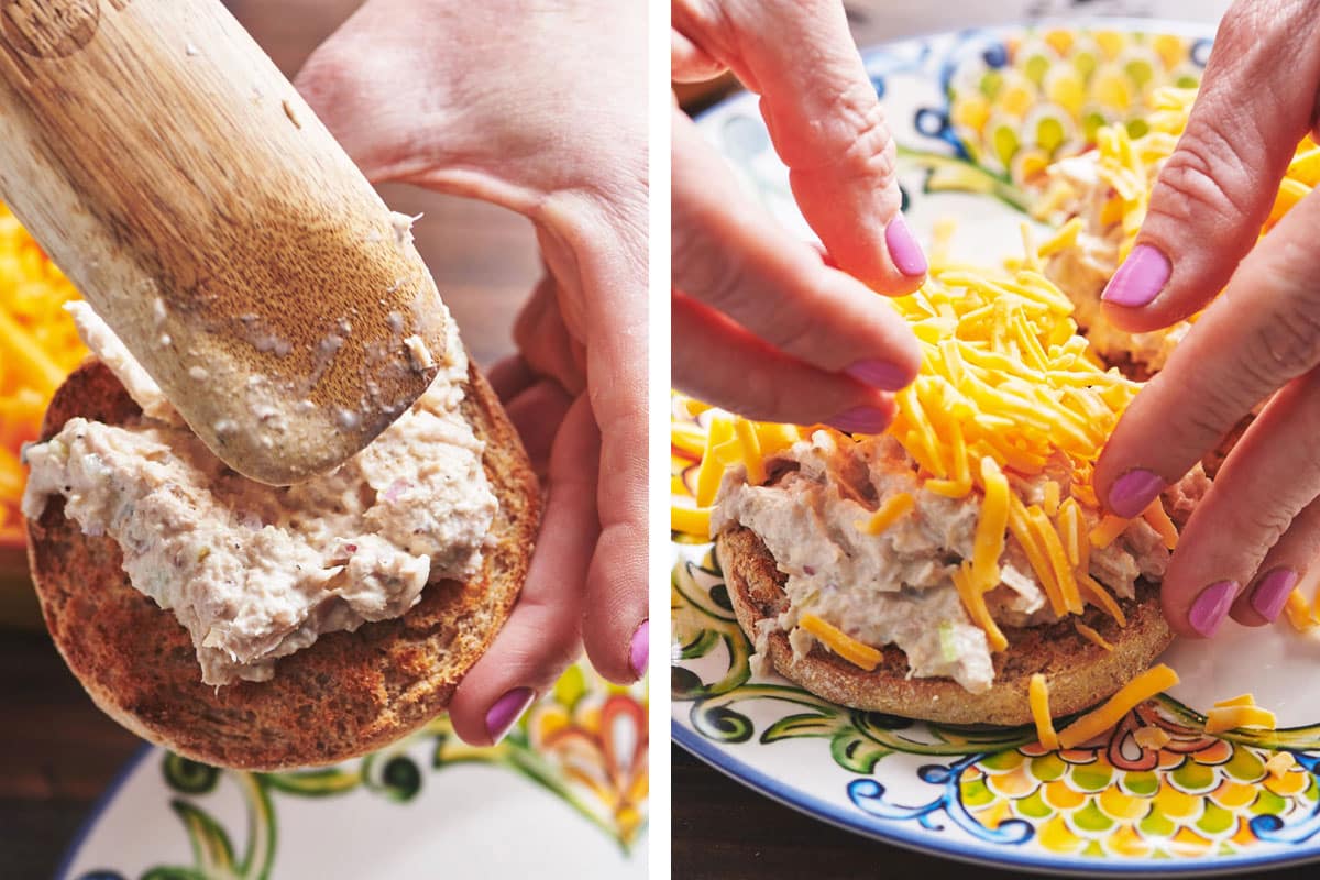 Woman spreading tuna salad and shredded cheddar cheese on English muffin.