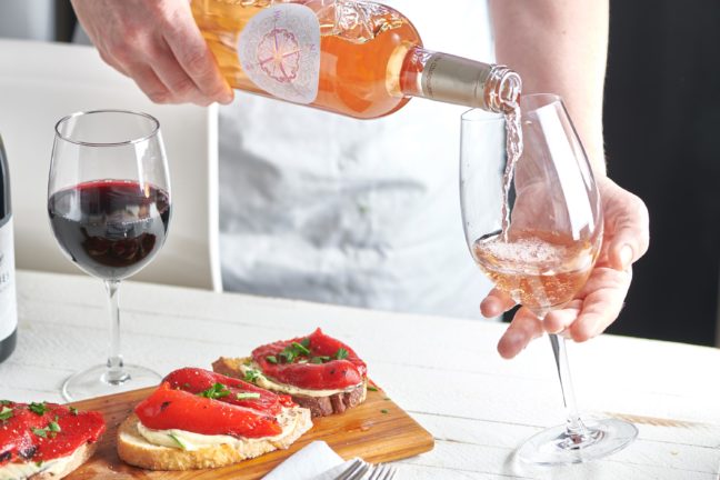 Bottle of La Ciboise rose pouring into a wine glass.