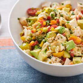 Chicken and Avocado Salad in white bowl next to spoon.