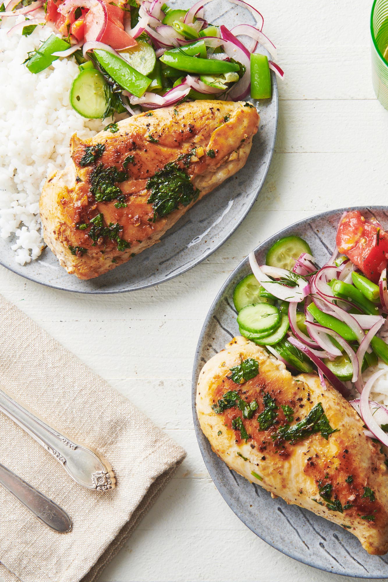 Cilantro Lime Chicken on plates with salads and rice.