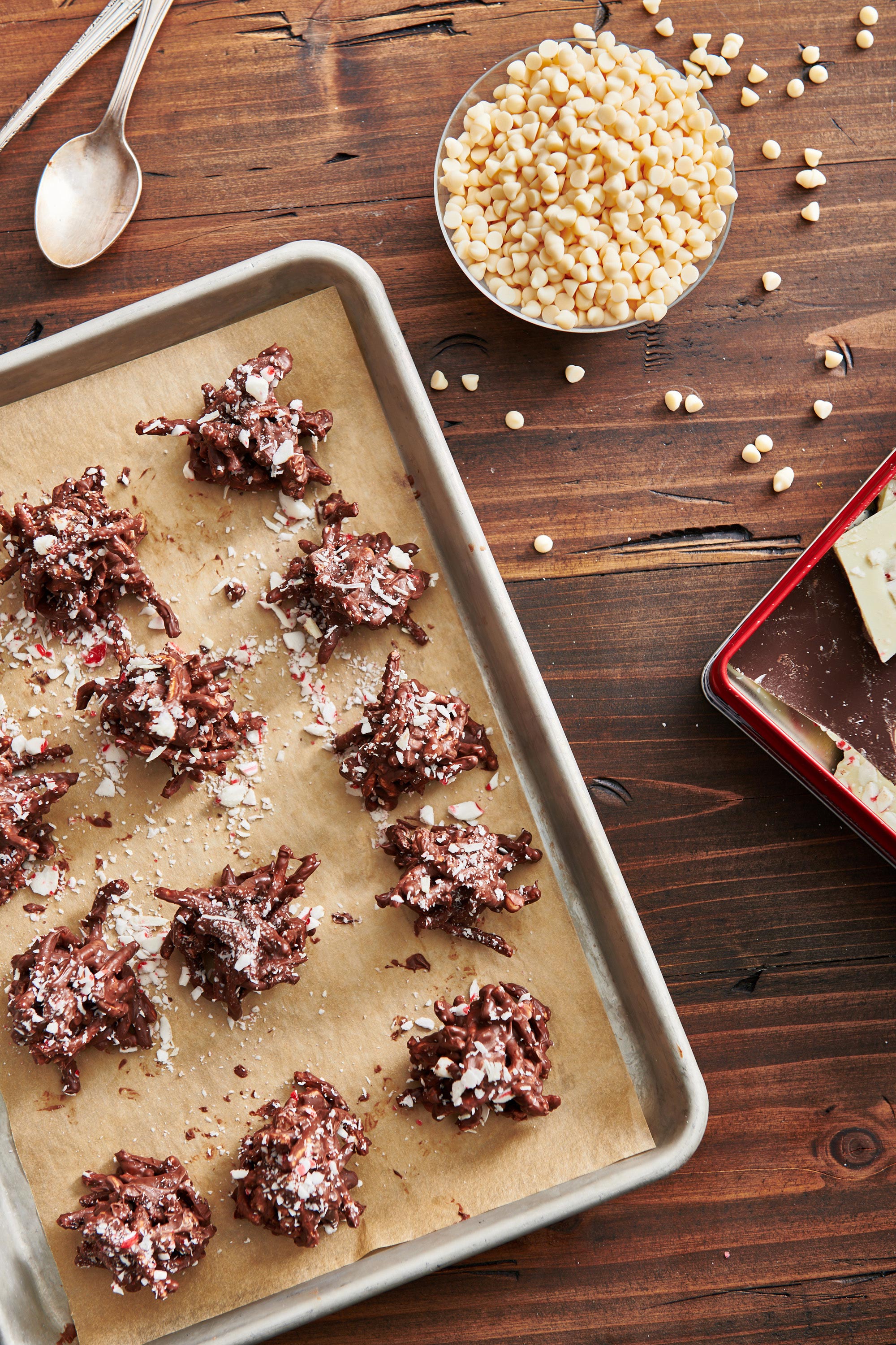 Baking sheet of Peppermint Bark Haystack Cookies on a wooden table.