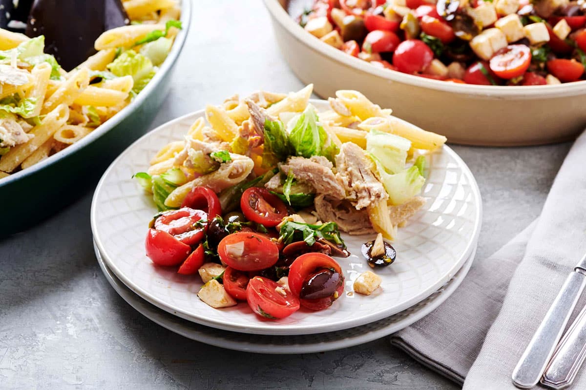 Tomato, Mozzarella and Basil Salad on a plate with pasta.