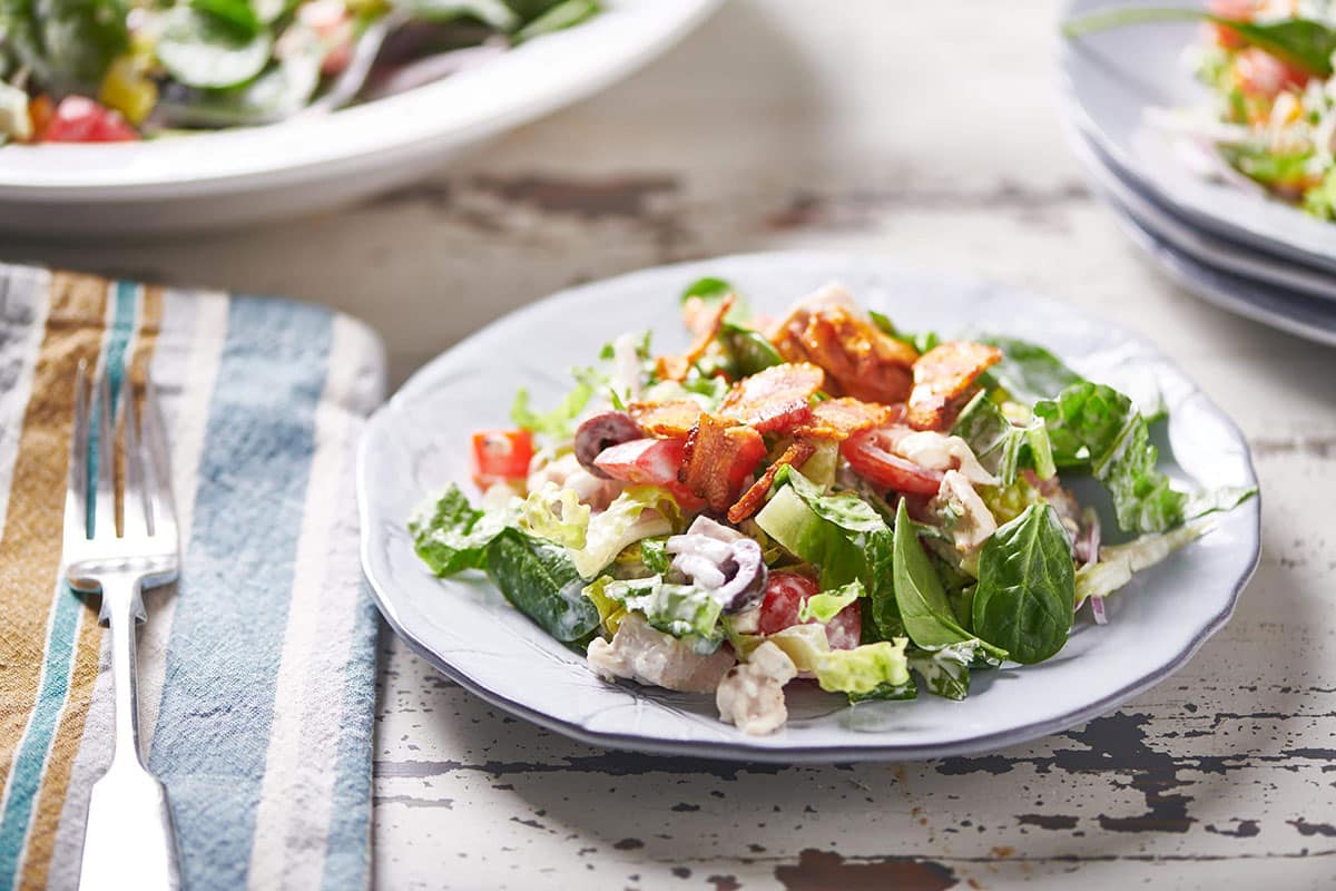 Chopped chicken salad on plate with blue cheese dressing.