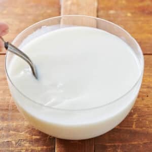 Homemade buttermilk substitute in white bowl with fork.