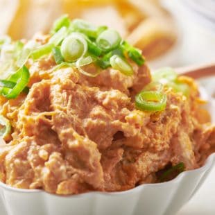 Buffalo Chicken Dip topped with chopped scallions.