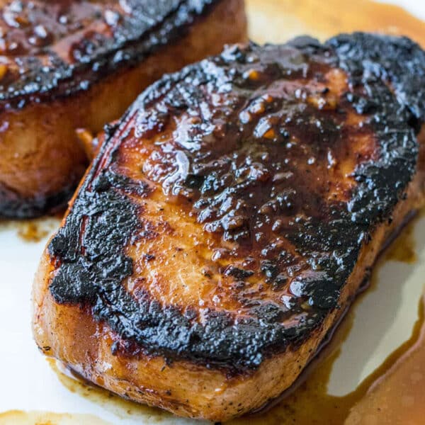 Korean marinated pork chop on plate with sauce.