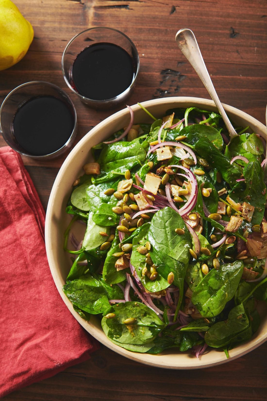 Spoon in a bowl of Spinach Salad with Roasted Fennel.