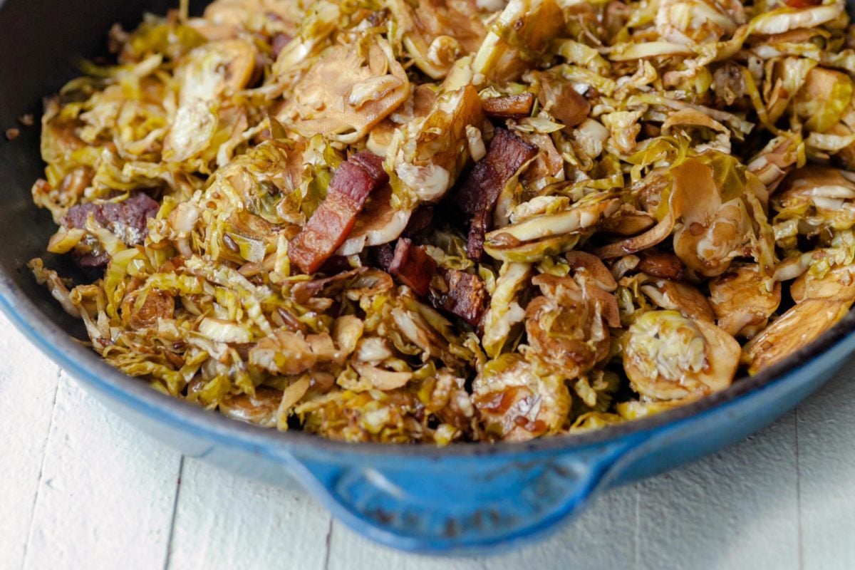 Blue skillet with Balsamic Glazed Shredded Brussels Sprouts with Bacon.