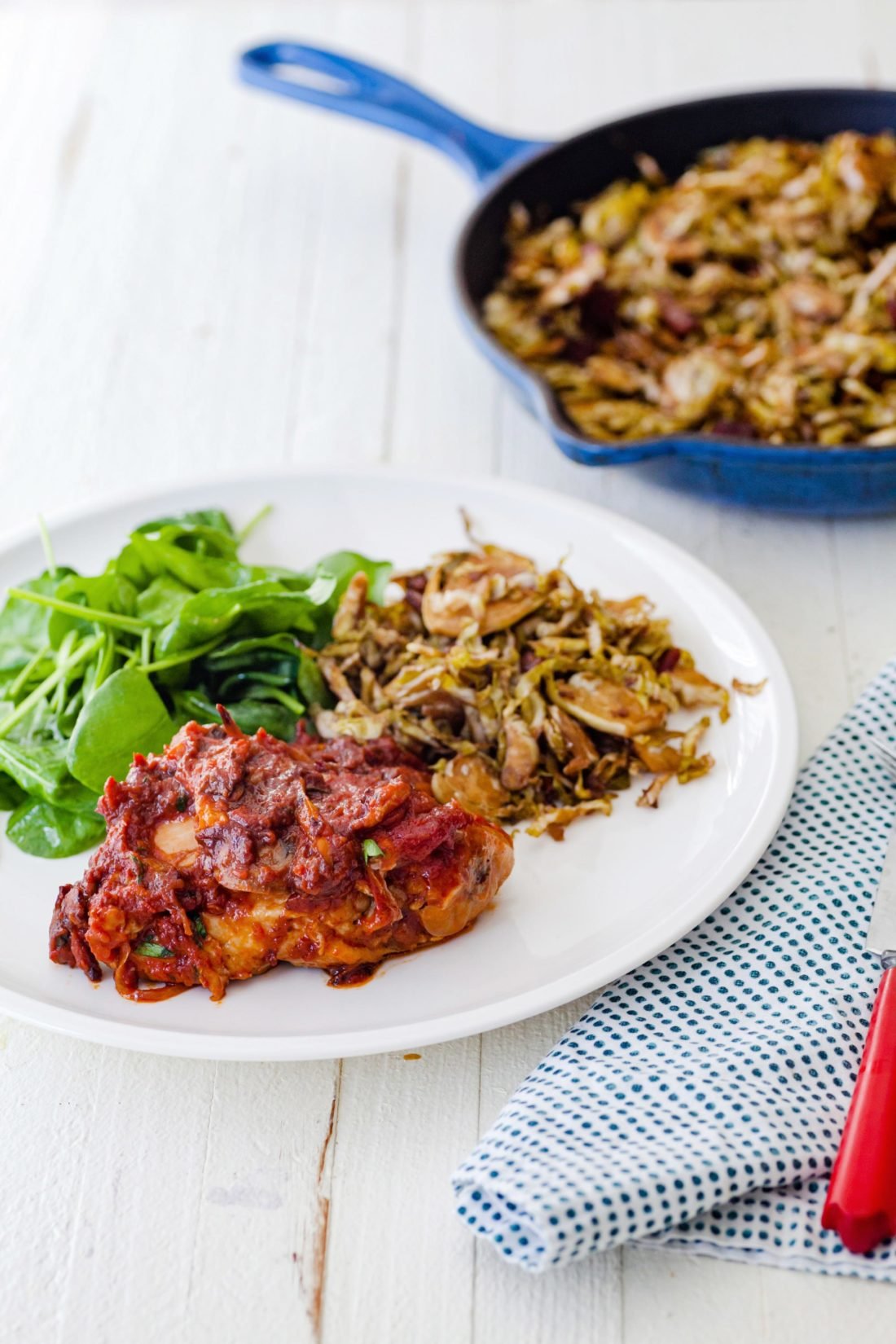 Balsamic Glazed Shredded Brussels Sprouts with Bacon on a plate with salad and meat.