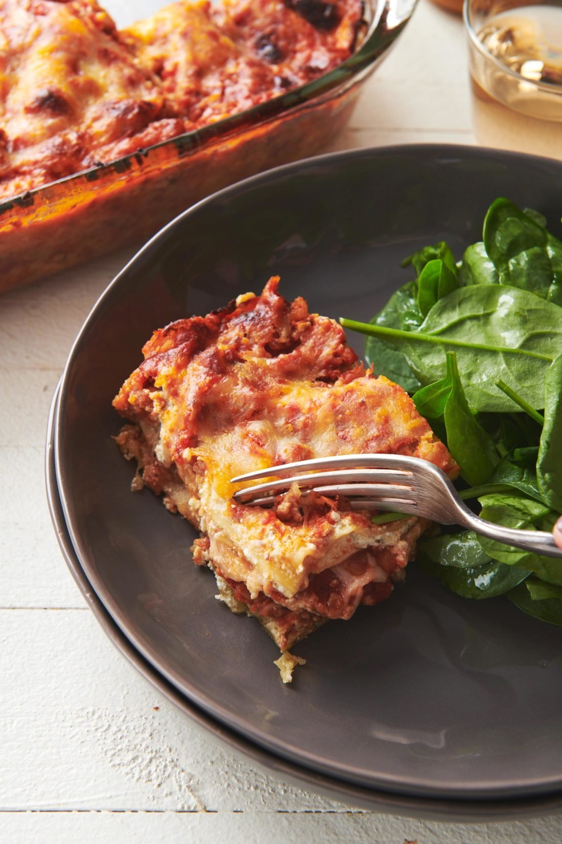 Fork cutting Turkey Lasagna on a plate.