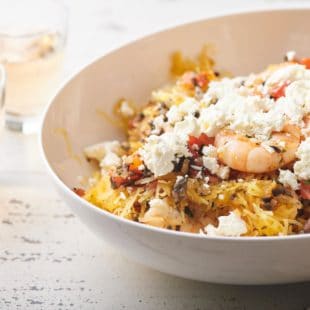 Bowl of Greek-Style Spaghetti Squash with Shrimp topped with feta cheese.
