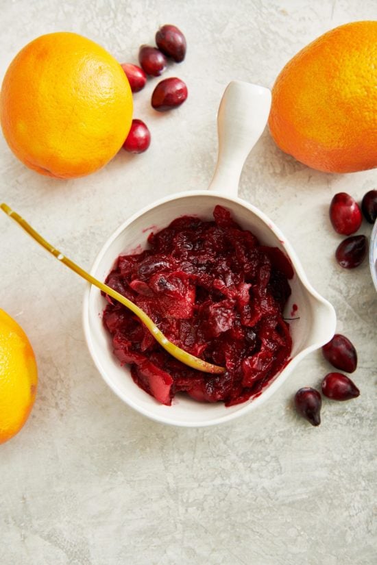 Small bowl of Cranberry Orange Sauce with a spoon.