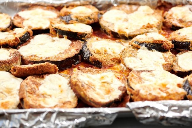 Coated eggplant slices topped with melted mozzarella.