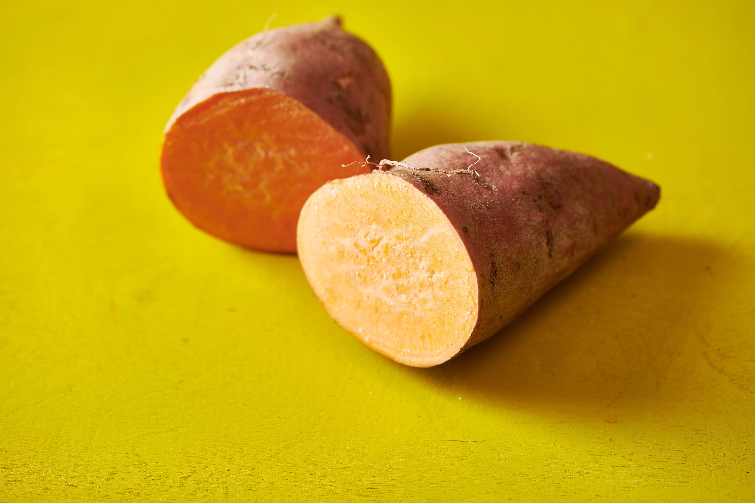 One sweet potato cut in half.