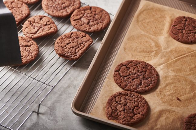Mexican Hot Chocolate Cookies on a wire rack and a lined baking sheet.