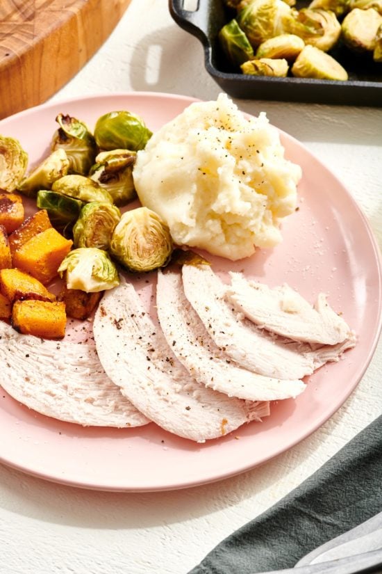 Plate of Turkey Breast, mashed potatoes, brussels sprouts, and sweet potatoes.