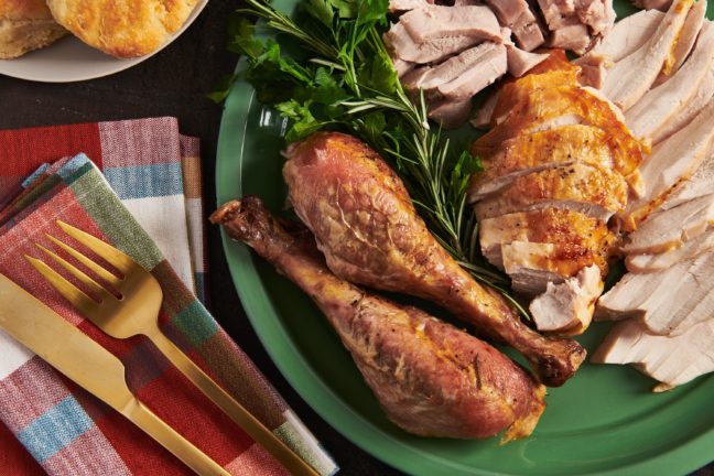 Green platter of sliced Roasted Thanksgiving Turkey.