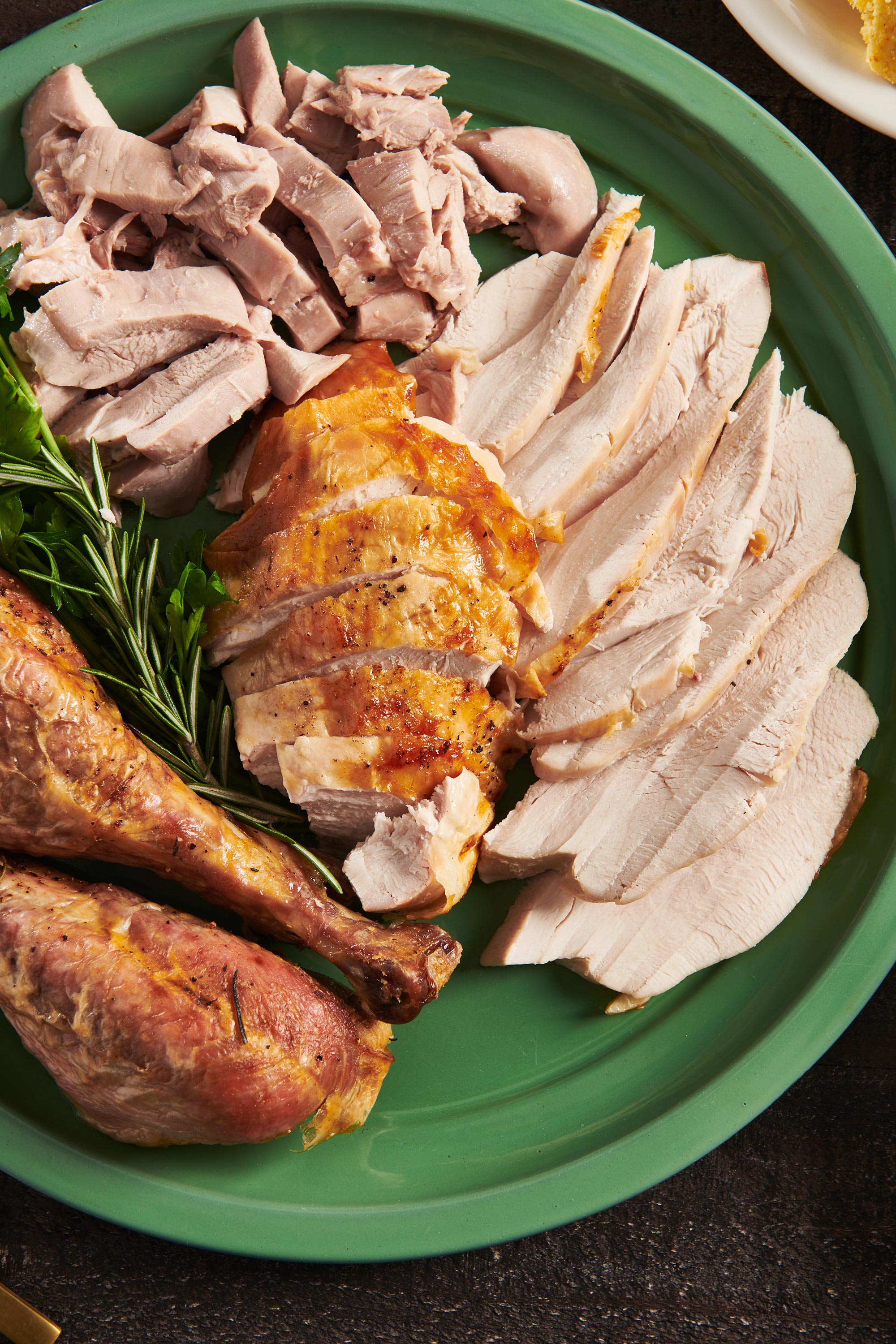 Sliced roasted turkey on serving platter.