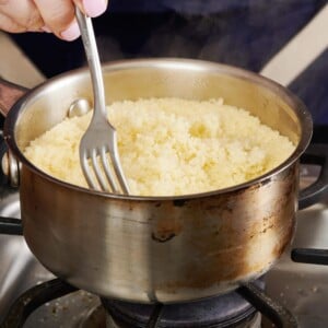 Fork stirring a pan of Couscous.