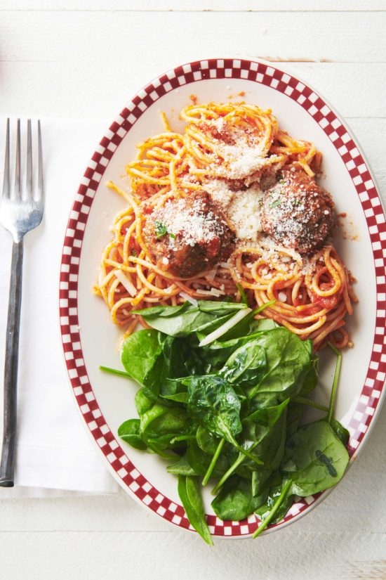 Plate of spinach and spaghetti with Italian Meatballs.