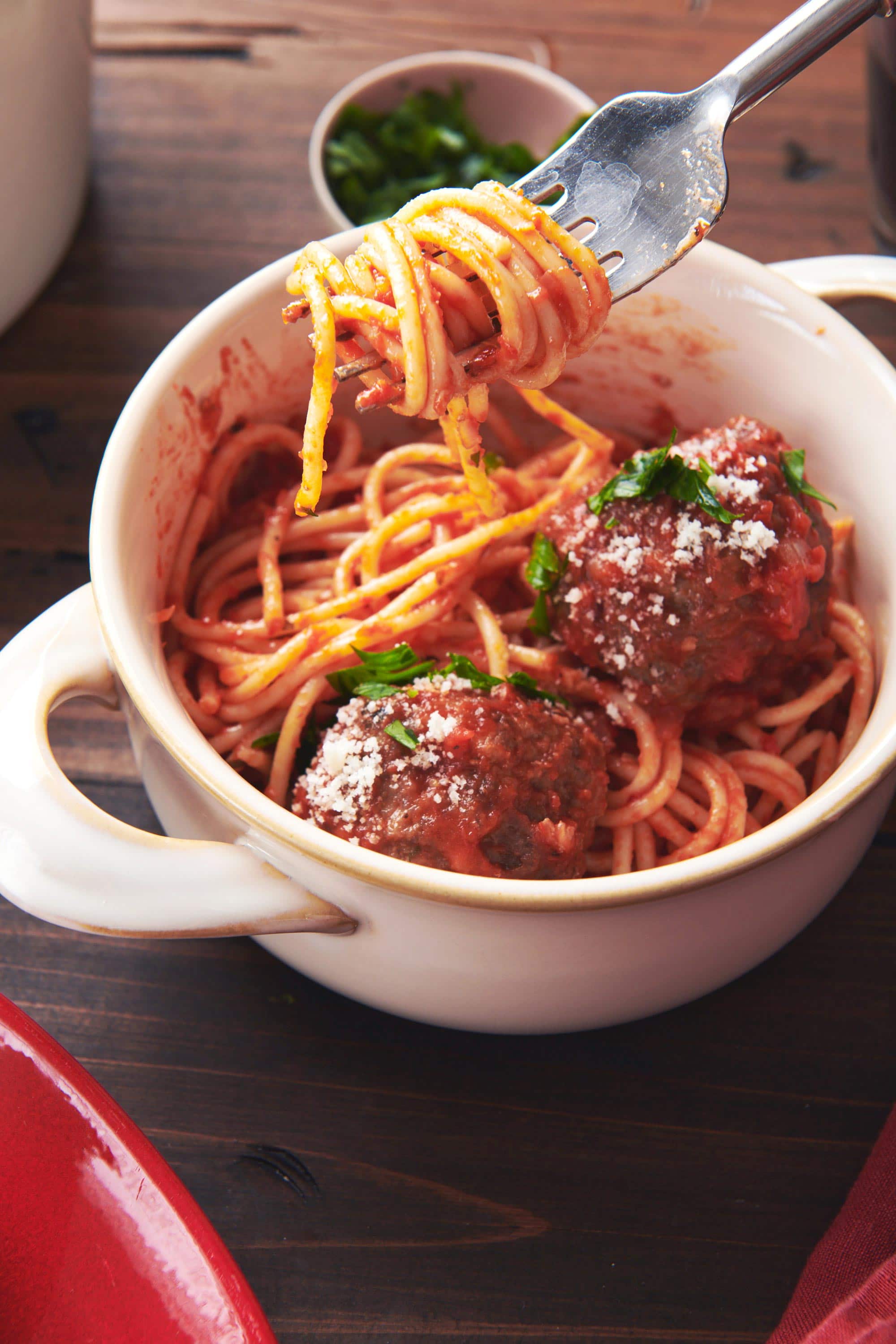 Fork grabbing noodles from a bowl of Spaghetti and Meatballs with Tomato Sauce.