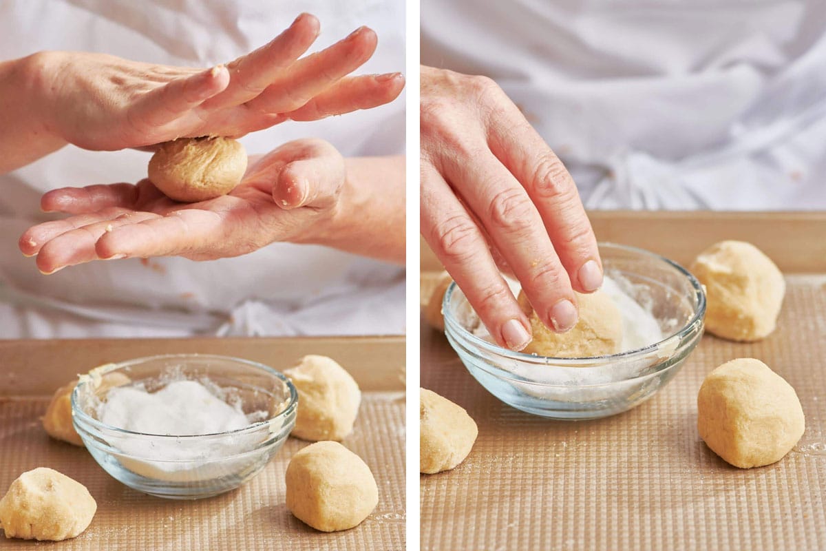 Woman rolling balls of sugar cookie dough and coating in sugar.