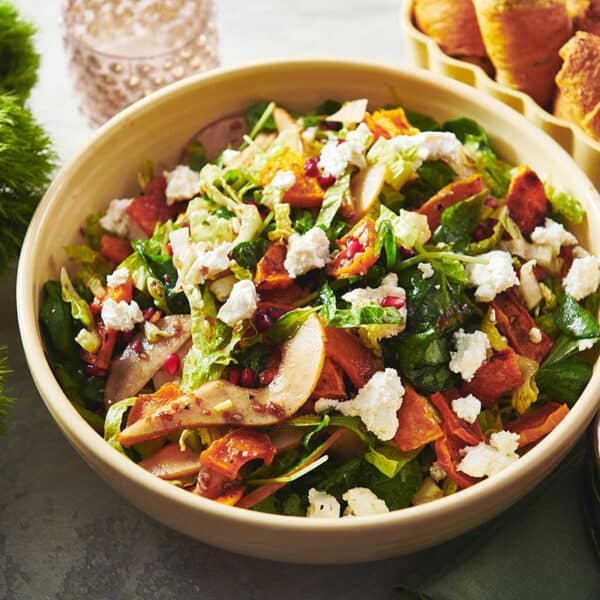 Green Salad with Roasted Butternut Squash, Pears, and Goat Cheese in bowl.