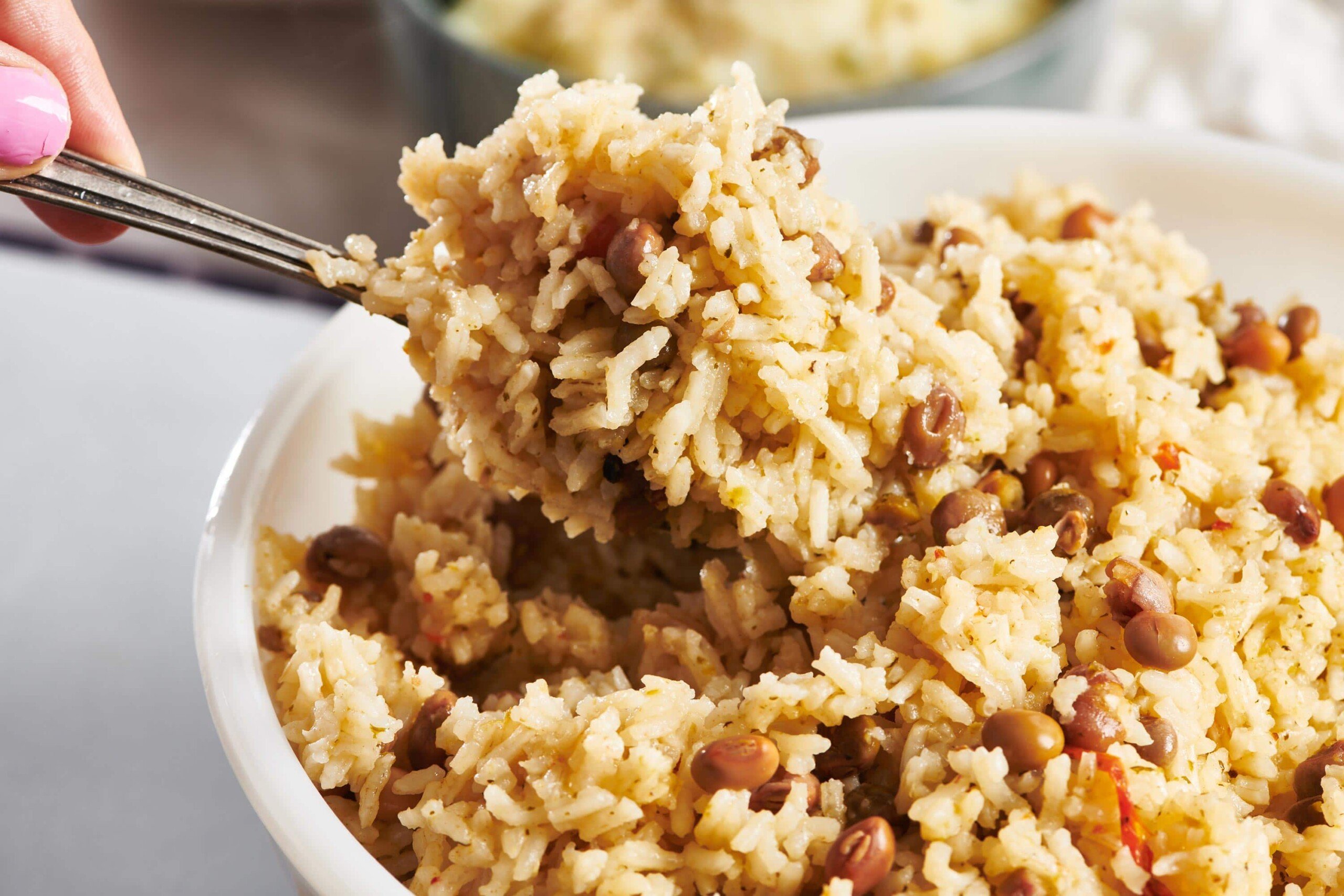 Scooping Arroz con Gandules with spoon.