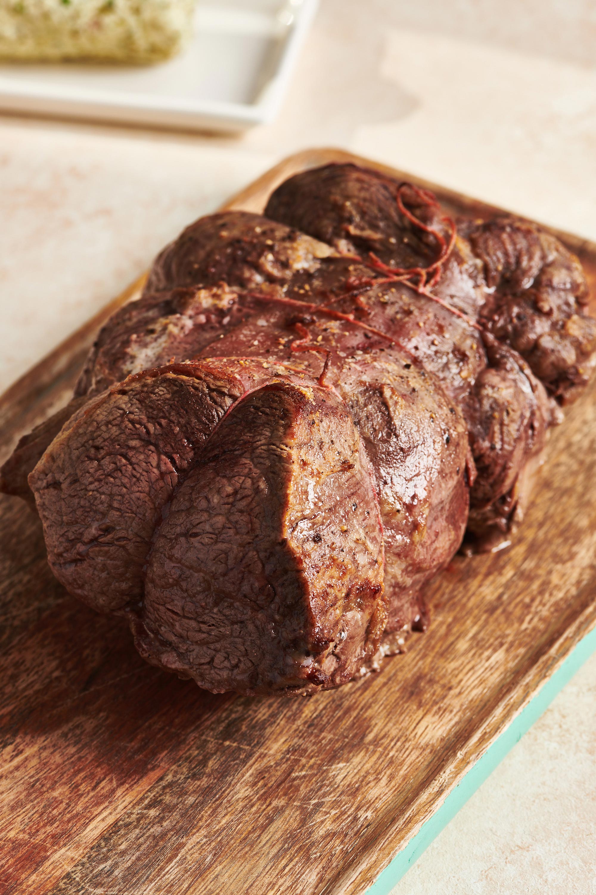 Beef Tenderloin Roast on wood cutting board.