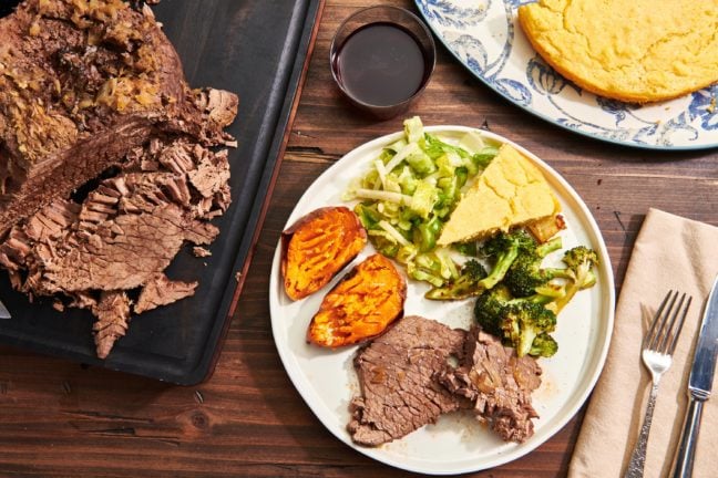 Plate of Pot Roast, broccoli, sweet potato, cornbread, and salad.