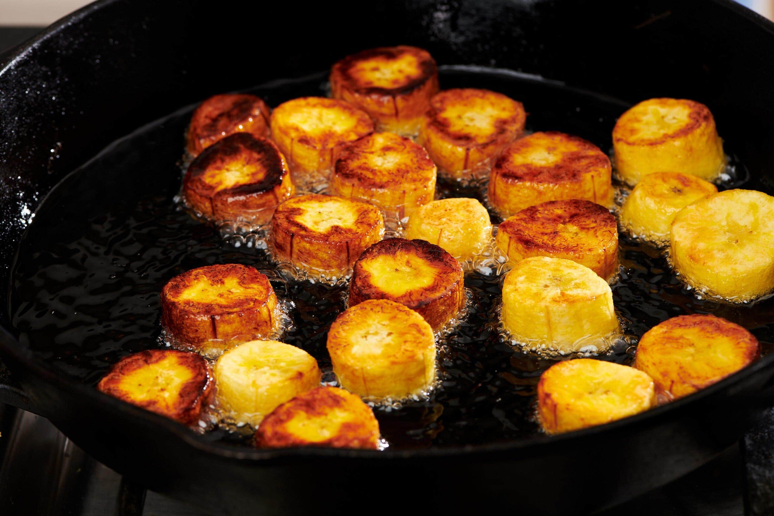 Plantains frying in a skillet.