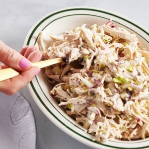 Scooping Chicken Salad out of bowl with fork.