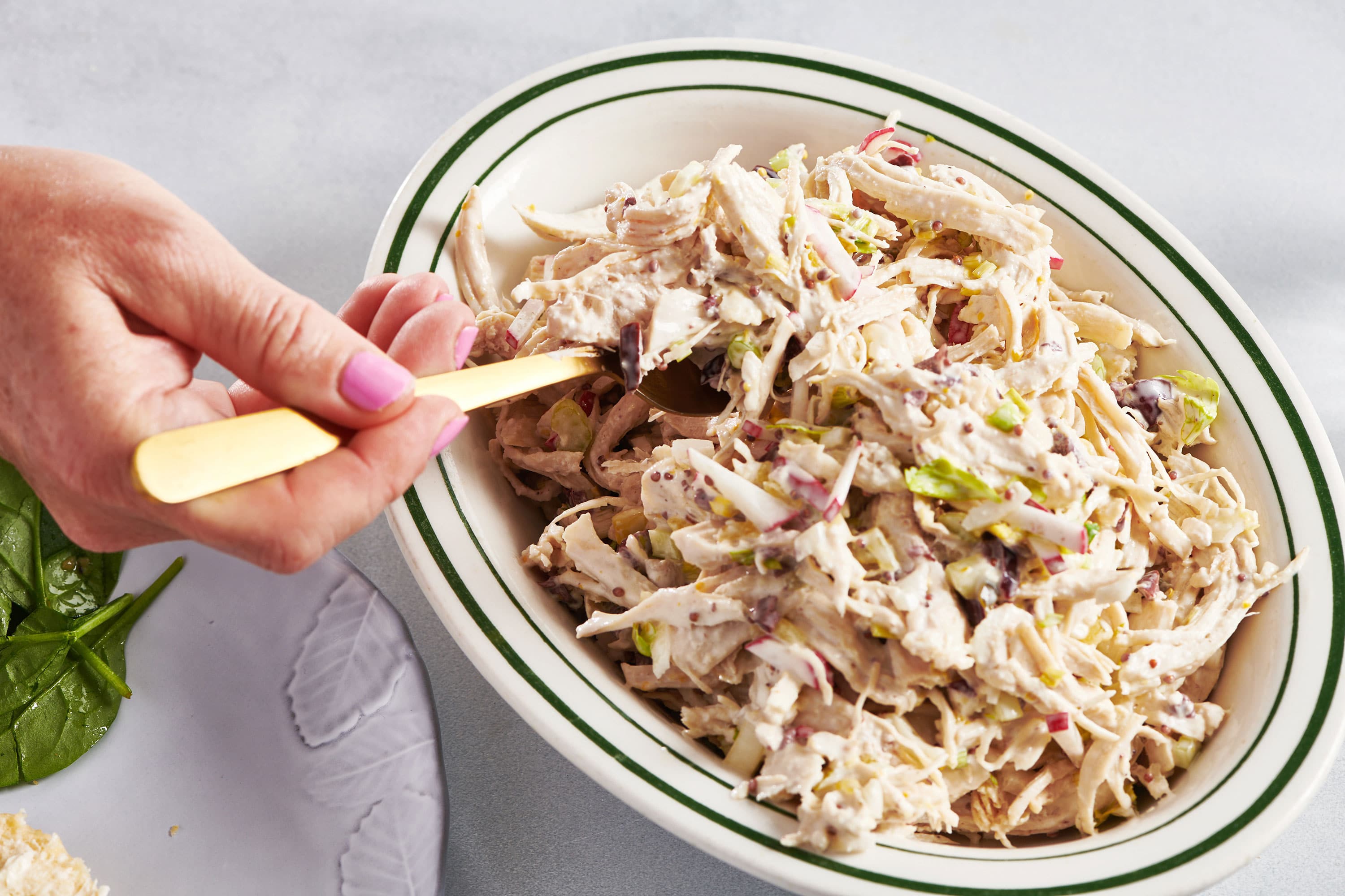 Scooping Chicken Salad out of bowl with fork.