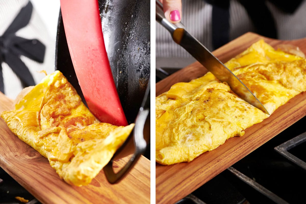 Sliding omelet onto cutting board and cutting in half for breakfast sandwich.