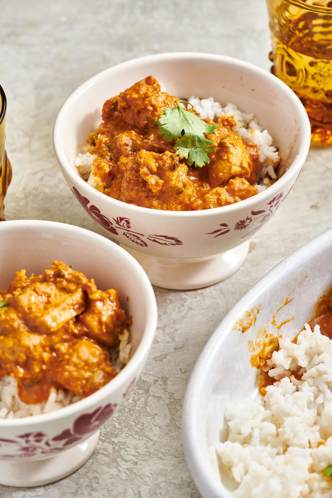 Two bowls of Butter Chicken (Murgh Makhani) and rice.