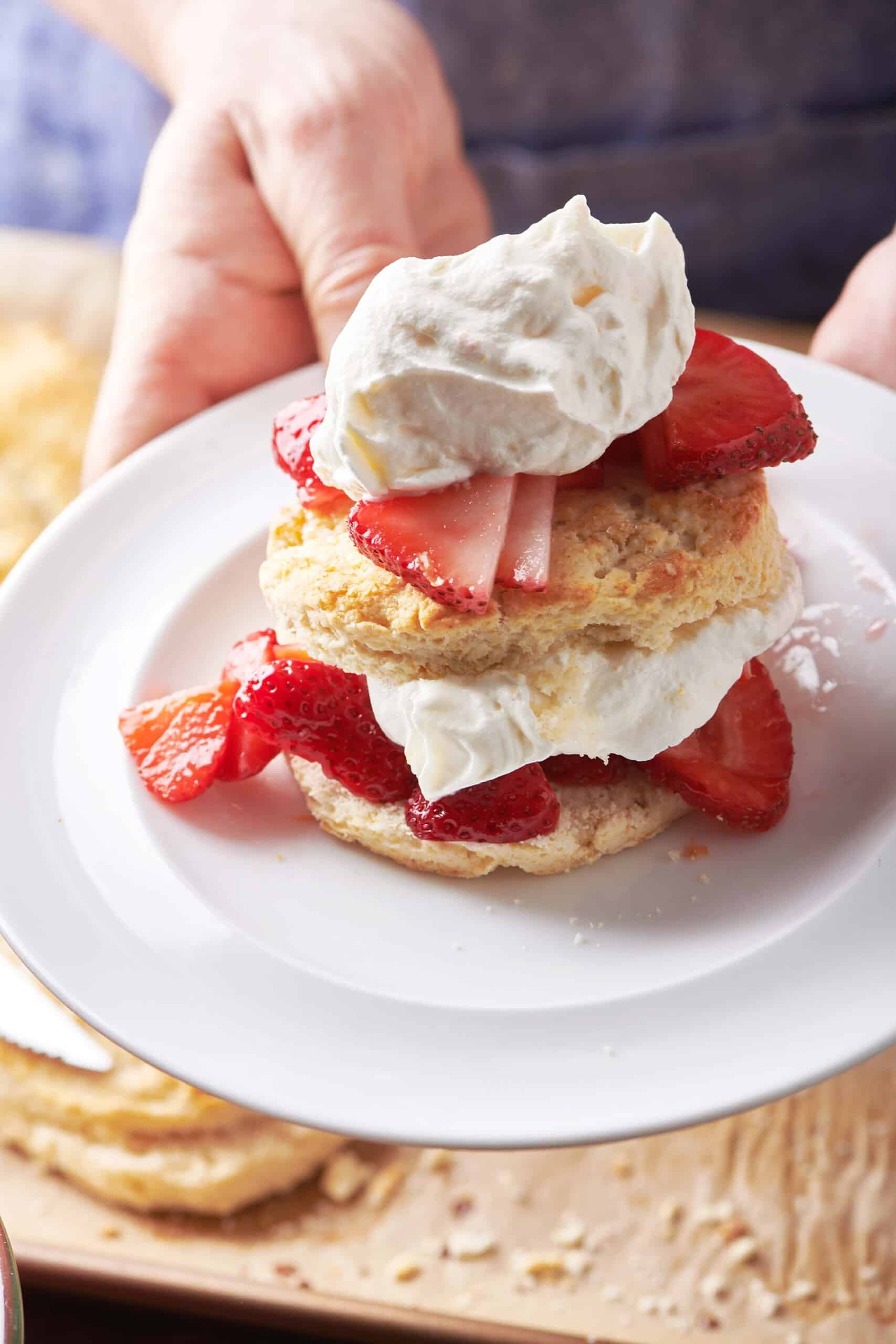 Woman holding plate with Classic Strawberry Shortcake.